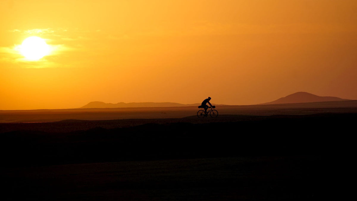 Samuel on a bike in an Africa african desert- Arkel's Ambassador